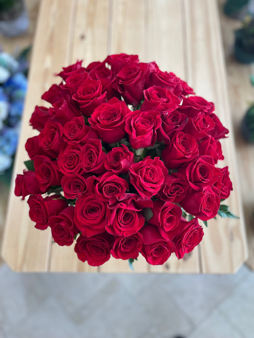 Top-down perspective of the 36 red roses arrangement showing dense, uniform placement of velvety crimson blooms.