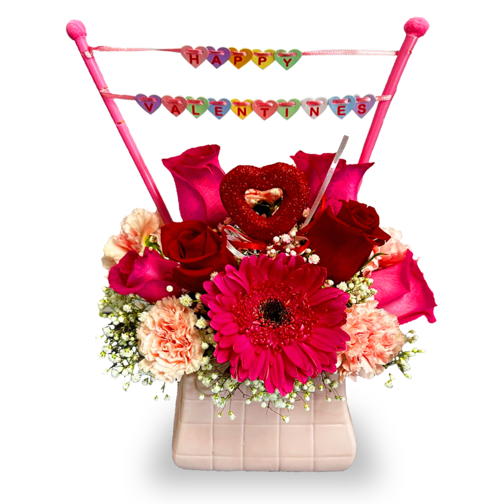 Close-up of the elegant nude-toned geometric square base displaying a vibrant deep pink gerbera daisy and fresh baby's breath.