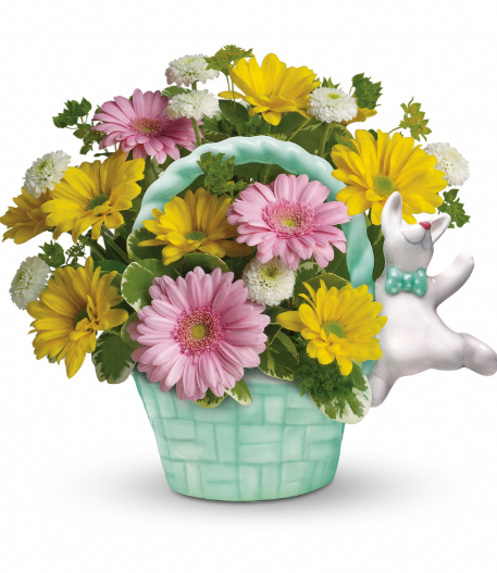 Colorful floral arrangement with pink gerberas, yellow daisies, and a decorative white bunny in a pastel green basket, perfect for delivery in Summerfield, Ocala, Orlando, The Villages, and Port St. Lucie.