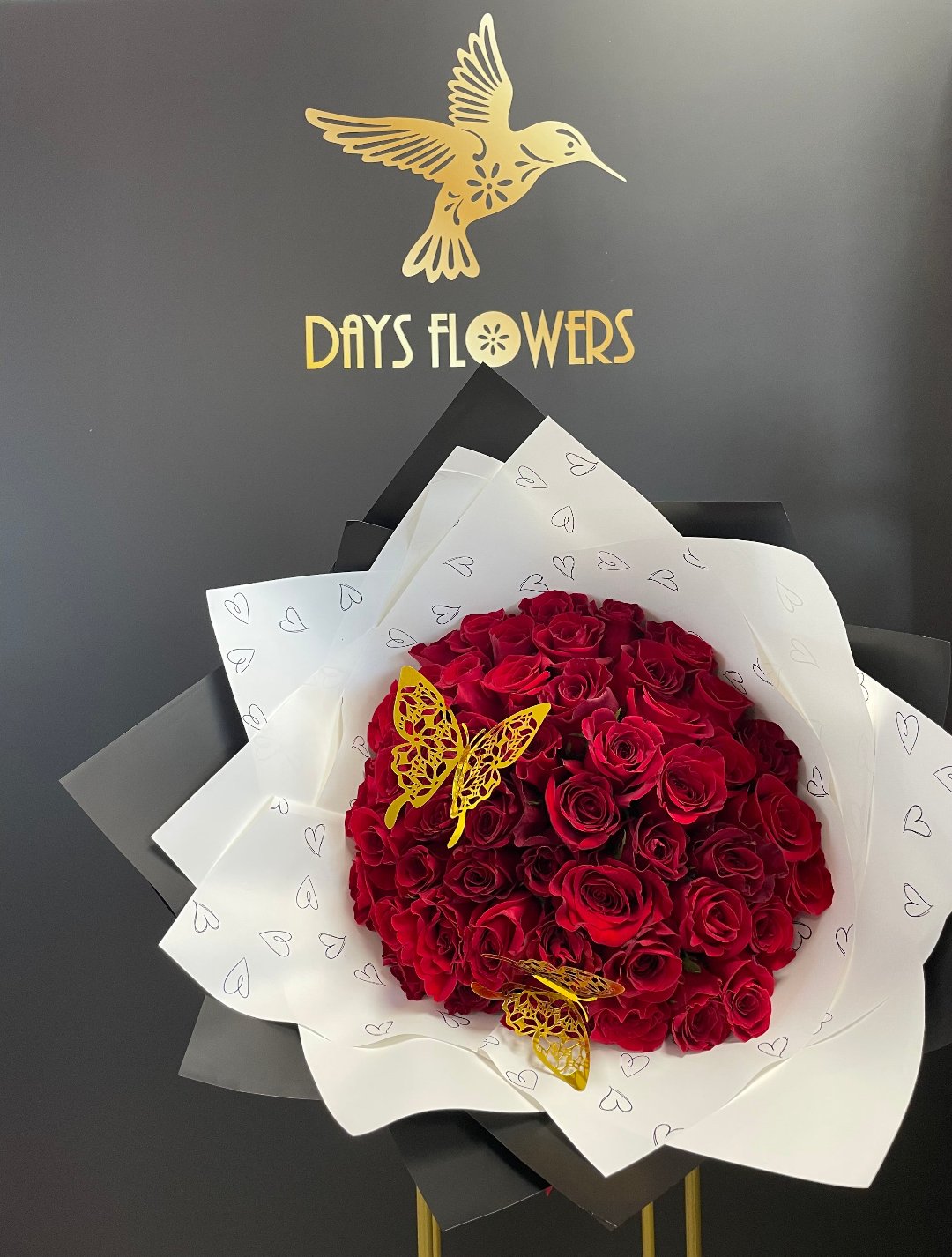 Luxurious red rose bouquet with golden butterflies from Days Flowers, perfect for special occasions in Florida areas.