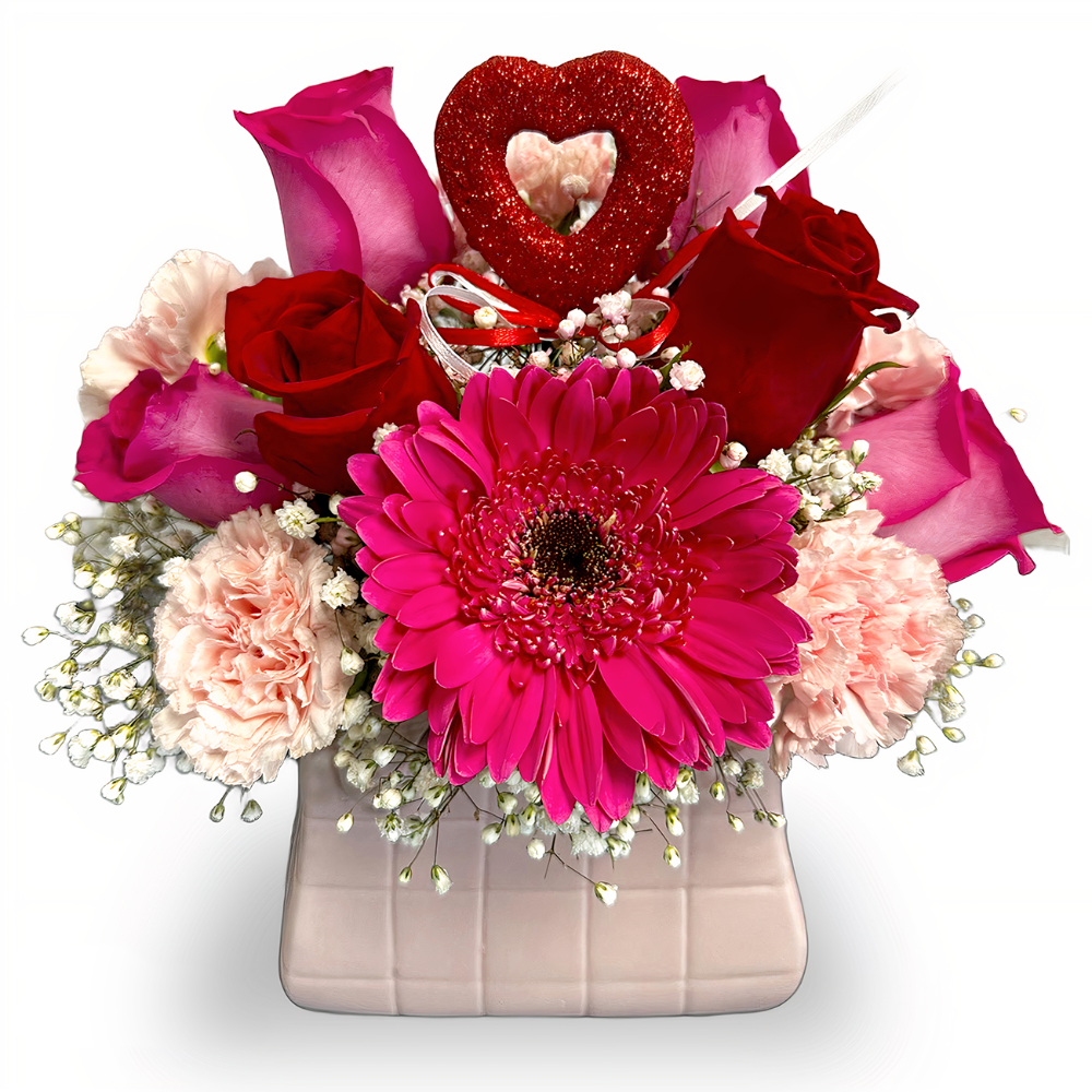 Romance in Every Petal flower arrangement with red and fuchsia roses, peach carnations, and a heart picker in a nude square box by Days Flowers Florida