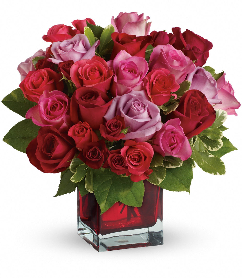 Top-down perspective of the Madly in Love Bouquet showing the dense placement of 50cm red roses and coral spray roses