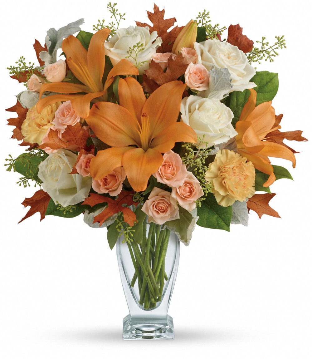 Seasonal Sophistication Bouquet featuring white roses, peach spray roses, and peach asiatic lilies in a clear glass couture vase by Days Flowers Florida.