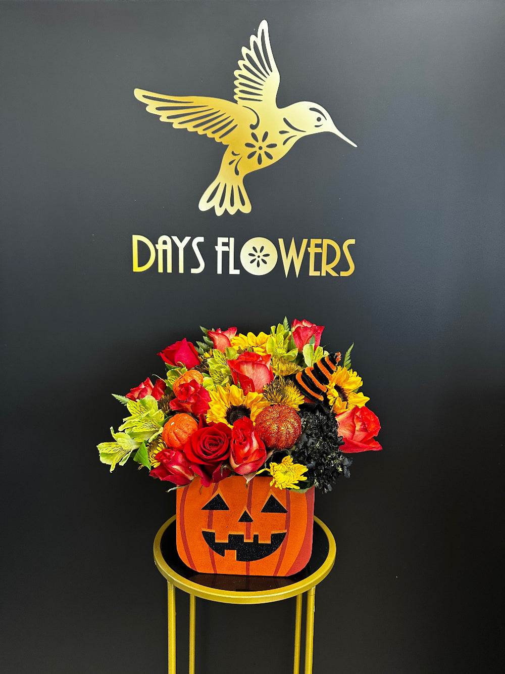 Side angle of the Halloween Magic arrangement styled on an October entry table setup.