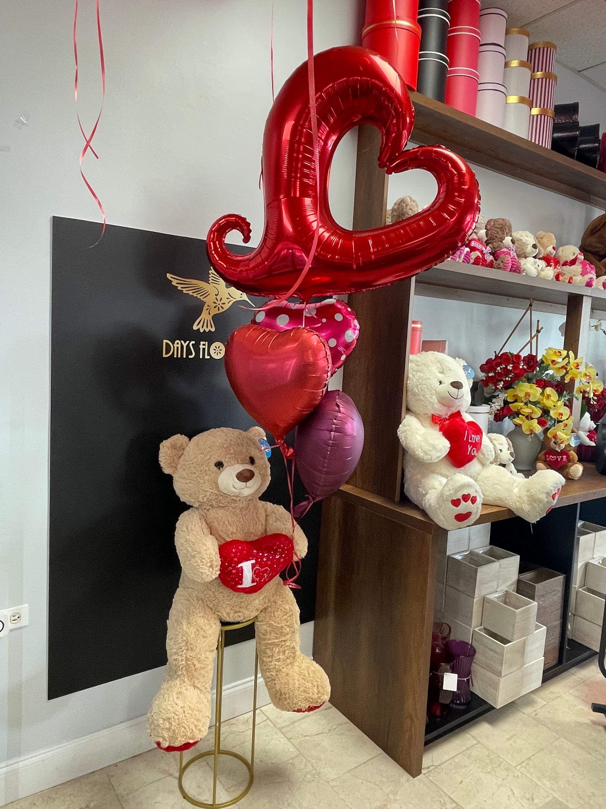 Days Flowers Florida: Bear Hug arrangement delivers smiles and hugs. Cuddly teddy bear and balloon assortment gift delivery in Port St. Lucie.