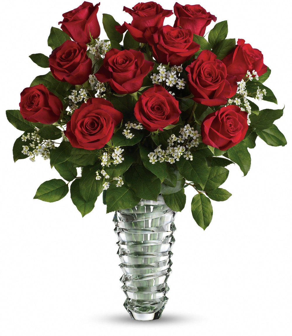 Close-up of the 10-inch Teleflora clear glass vase displaying the sculpted swirling ring pattern and fresh red rose stems