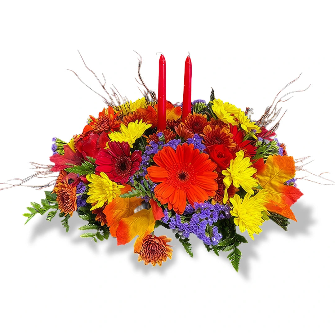 Thanksgiving Floral Arrangement with Candles featuring orange, red, and yellow fall flowers with two red taper candles by Days Flowers Florida