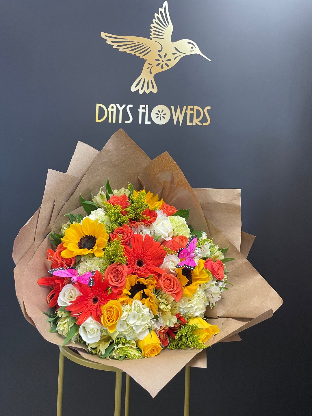 Bright bouquet with red gerberas, yellow sunflowers, white roses by Days Flowers, delivery in Florida.