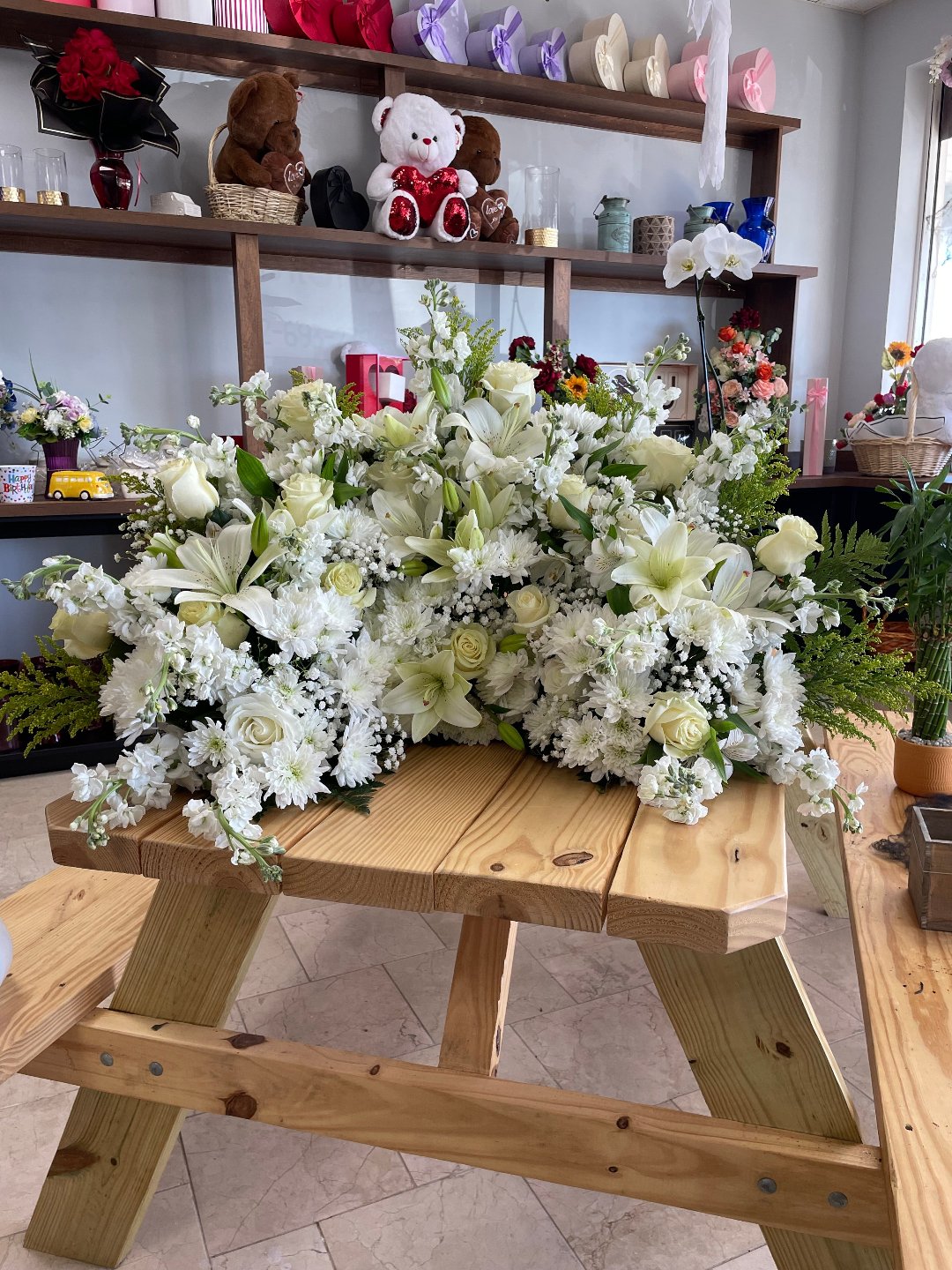 Elegant white floral arrangement featuring lilies and roses, perfect for gifting in Summerfield, Ocala, Orlando, The Villages, and Port St. Lucie.