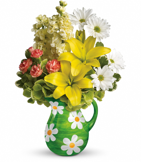 A vibrant floral arrangement featuring yellow lilies, red carnations, white daisies, and green foliage in a green vase with white flower accents, perfect for delivery in Summerfield, Ocala, Orlando, The Villages, and Port St. Lucie.