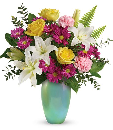 Bright floral arrangement with yellow roses, pink carnations, and white lilies in a green vase, perfect for delivery in Summerfield, Ocala, Orlando, The Villages, and Port St. Lucie.